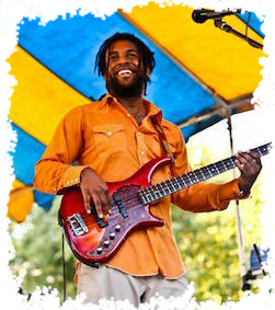 Orange Shirt playing bass with a smile